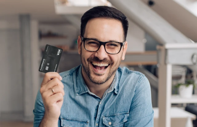 Man Smiling Holding FirstOntario Visa Credit Card