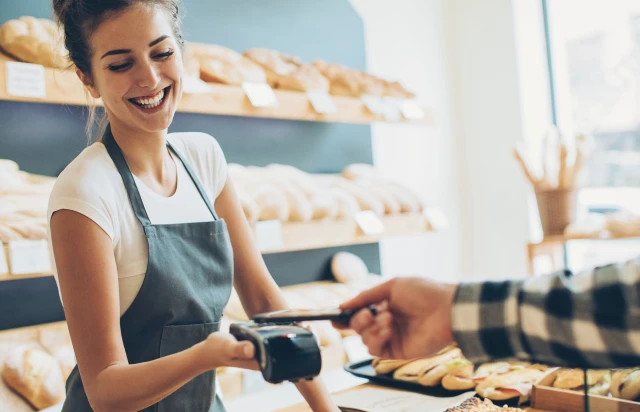 Bakery Worker Cashing Out Customer with Tap
