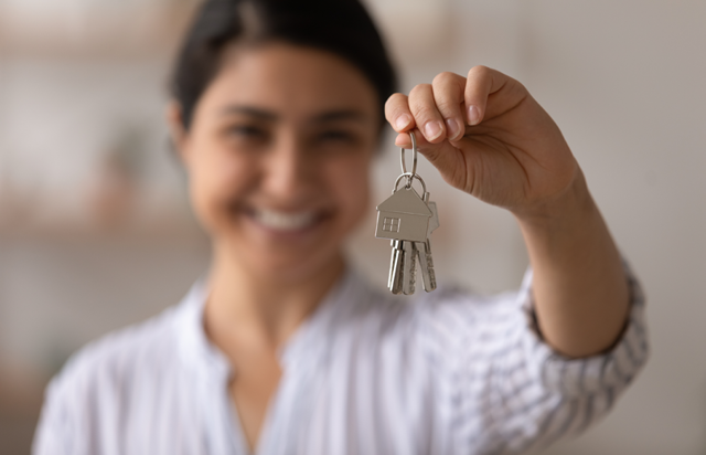 Woman Holding Keys to New Home